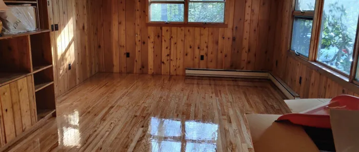 Hardwood floor in a room with windows